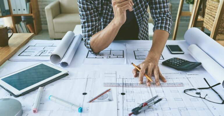 Cropped,Image,Of,Architect,Working,With,Construction,Plans